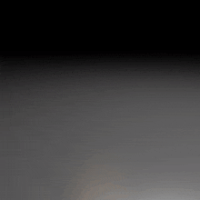 a cell phone with a speaker on it is laying on a gray surface
