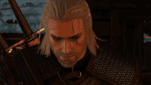 a man with white hair and a beard is holding a large sword