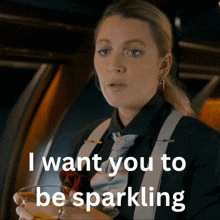 a woman in a suit and suspenders is holding a drink and says i want you to be sparkling