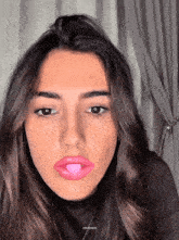 a close up of a woman 's face with a pink bubble in her mouth and the words zeusgifs at the bottom