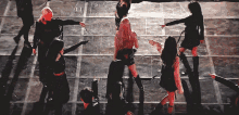 a group of women are dancing on a stage and one is pointing at something