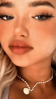a close up of a woman wearing a necklace