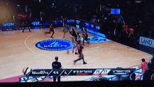 a basketball game is being played on a court that has a sign that says von on it