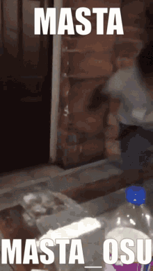 a bottle of soda sits on a table in front of a brick wall with a caption that says masta