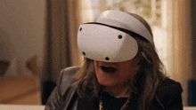 a woman wearing a virtual reality headset with her mouth open .