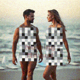 a man and a woman are walking on the beach with their bodies covered in checkered squares