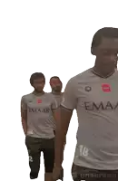 a group of men wearing emaar shirts are walking