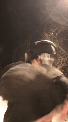 a blurry picture of a person wearing a helmet with the letter n on it