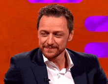 a man with a beard in a suit and white shirt