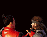 a man with a beard is pointing at a woman with a bun