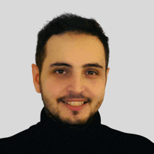 a man with a beard is smiling for the camera