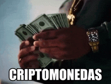 a man is holding a bunch of money in his hands with the words " cryptomonedas " written below him