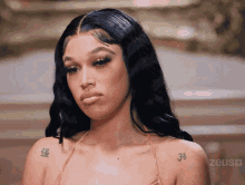 a woman with a tattoo on her shoulder that says 3