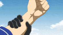 a person is holding another person 's wrist with their fist in the air