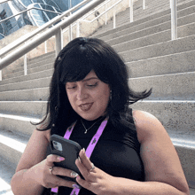 a woman wearing a lanyard that says ' a ' on it