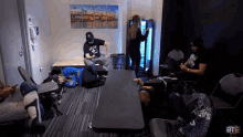 a group of people are sitting around a table in a room that says bte on the bottom