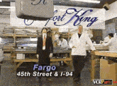 two men standing in front of a sign that says fort king on it
