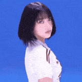 a woman with long black hair is wearing a black t-shirt with white stripes and a necklace .