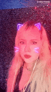 a woman with pink hair is wearing a cat ear mask