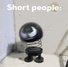 a black spring toy with the words short people written on the bottom