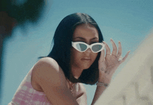 a woman wearing sunglasses has a tattoo on her wrist that says ' i love you '