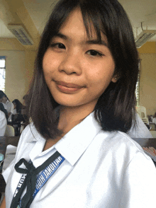 a girl wearing a white shirt with a lanyard that says ' rbhj high '