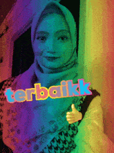 a woman giving a thumbs up with a sign that says terbaikk on it