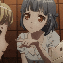 a girl with a blue hair and brown eyes is pointing at something