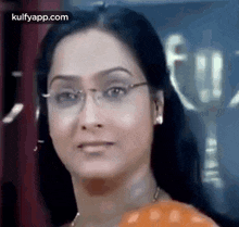 a close up of a woman wearing glasses .