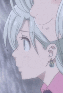 a close up of a person 's ear with a blue stone in it .