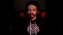 a man with a beard is wearing a spiderman shirt