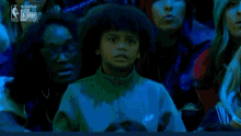 a young boy is crying in a crowd of people watching a basketball game sponsored by the nba