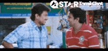 two men talking in front of a star tamil chat banner