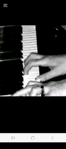 a black and white photo of someone playing a piano