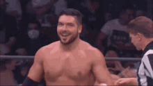 a wrestler is laying on the ground in a ring that says aew on the side