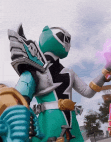 a green and silver power ranger is holding a purple object