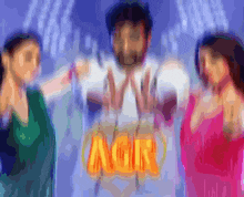 a blurry picture of a man and two women with the word agir in orange letters