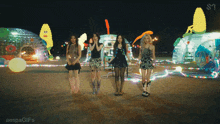 a group of girls are standing in front of a display of ice sculptures and a sign that says aespagifs