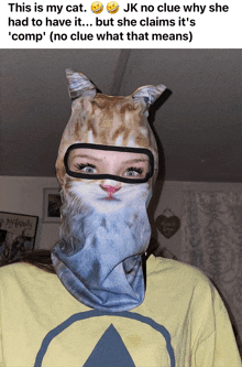 a woman wearing a cat mask has a yellow shirt on