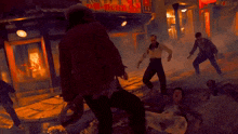 a blurry picture of a man in a hat fighting another man in a dark room .