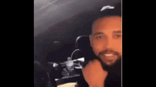 a man is sitting in the back seat of a car .