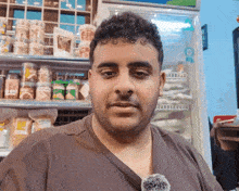 a man standing in front of a refrigerator with a bottle that says ' a ' on it