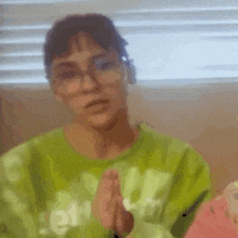 a blurry picture of a woman wearing a green sweater with the word reebok on the front