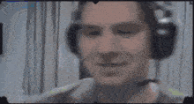 a man wearing headphones is brushing his teeth with a toothbrush while wearing a microphone .