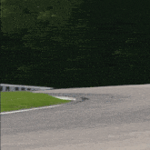 a race car is going around a curve on a road