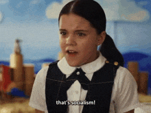 a young girl in a school uniform is saying that 's socialism