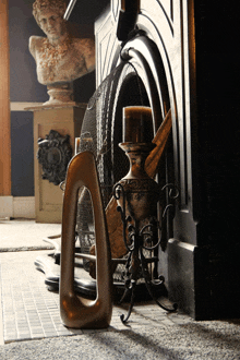 a fireplace with a statue on the mantle and a candle in it