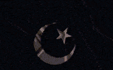 a fireworks display with a crescent moon and star in the foreground
