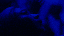 a close up of a person 's face with blue background