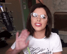 a woman wearing glasses and a t-shirt that says the power